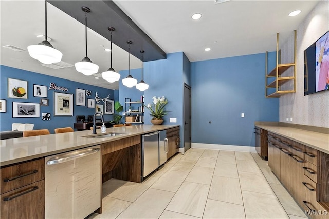 680 6th Ave NE Unit 3310, Tuscaloosa, AL 35404 - kitchen with stainless steel dishwasher, a sink, light countertops, decorative light fixtures, and recessed lighting