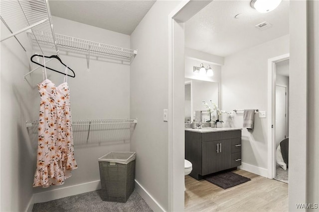 680 6th Ave NE Unit 3310, Tuscaloosa, AL 35404 - bathroom with vanity, wood finished floors, baseboards, and toilet