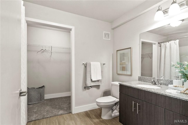 680 6th Ave NE Unit 3310, Tuscaloosa, AL 35404 - full bath with wood finished floors, a walk in closet, vanity, and toilet