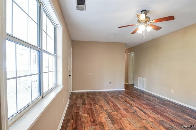 spare room with dark hardwood / wood-style floors and ceiling fan