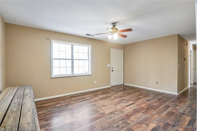 unfurnished room featuring dark hardwood / wood-style floors and ceiling fan