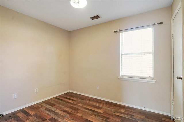 unfurnished room featuring dark wood-type flooring