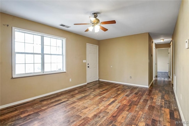 unfurnished room featuring dark wood-type flooring and ceiling fan