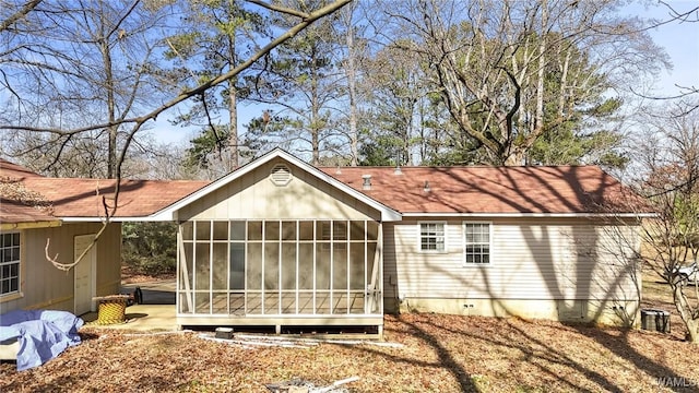 rear view of property with a sunroom