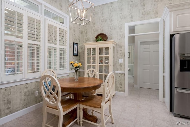 4032 Carousel Cir, Tuscaloosa, AL 35406 - dining area with a chandelier, wallpapered walls, and light tile patterned flooring