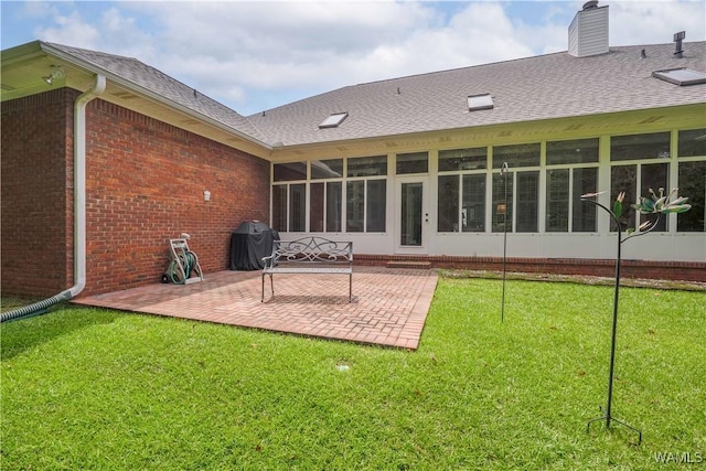 4032 Carousel Cir, Tuscaloosa, AL 35406 - back of house featuring a patio area, a sunroom, brick siding, a yard, and a chimney