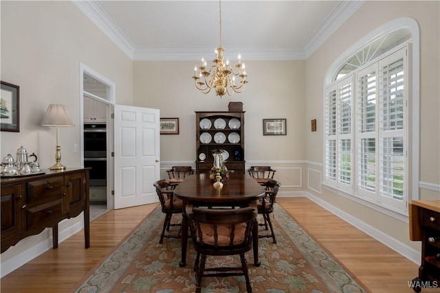 4032 Carousel Cir, Tuscaloosa, AL 35406 - dining space featuring healthy amount of natural light, light wood-type flooring, ornamental molding, and a chandelier