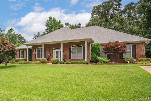 4032 Carousel Cir, Tuscaloosa, AL 35406 - view of front of house with brick siding, a front yard, and roof with shingles