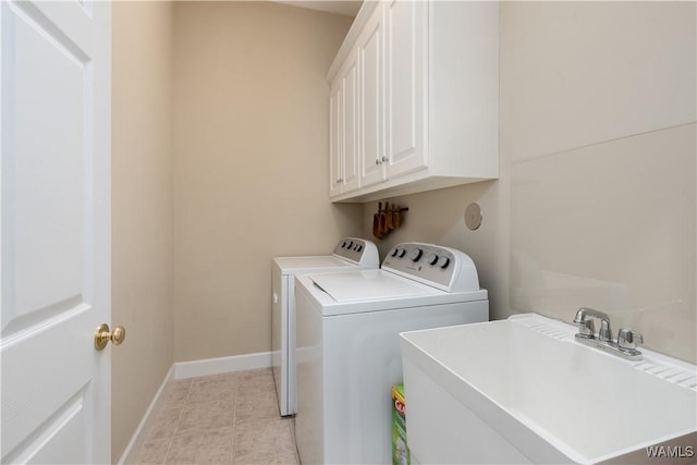 4032 Carousel Cir, Tuscaloosa, AL 35406 - washroom featuring washing machine and clothes dryer, cabinet space, and light tile patterned floors