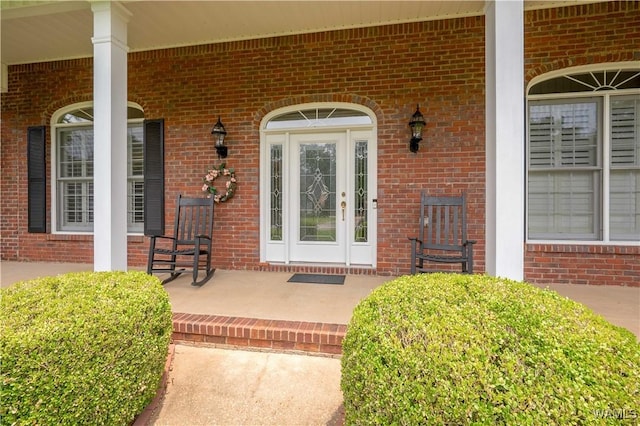 4032 Carousel Cir, Tuscaloosa, AL 35406 - doorway to property featuring a porch and brick siding