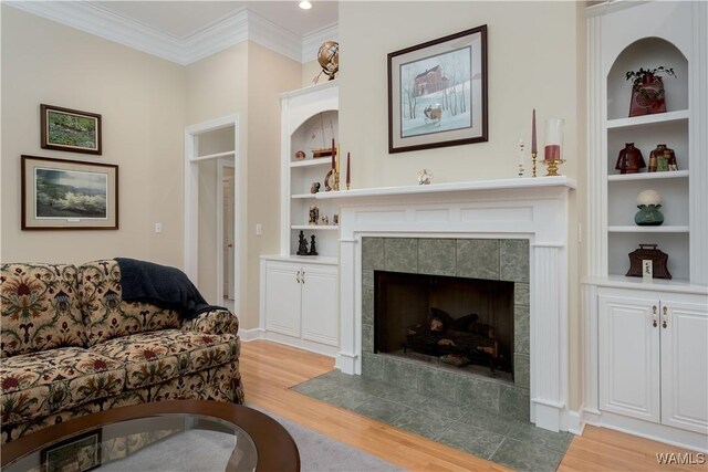 4032 Carousel Cir, Tuscaloosa, AL 35406 - living room featuring light wood-style floors, built in shelves, a fireplace, and ornamental molding