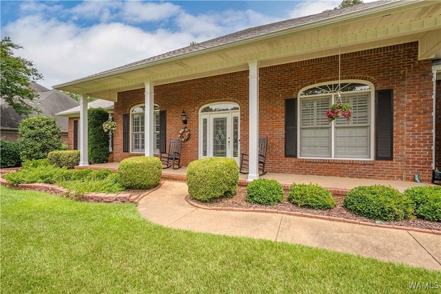 4032 Carousel Cir, Tuscaloosa, AL 35406 - doorway to property with a porch, brick siding, and a yard