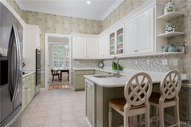 4032 Carousel Cir, Tuscaloosa, AL 35406 - kitchen featuring stainless steel appliances, a peninsula, light countertops, a kitchen breakfast bar, and open shelves