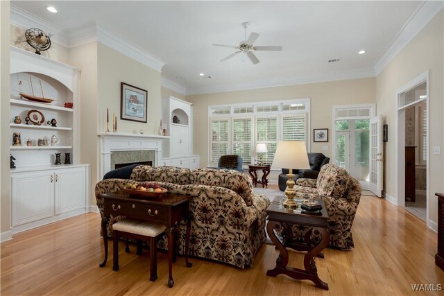 4032 Carousel Cir, Tuscaloosa, AL 35406 - living room featuring ceiling fan, a tile fireplace, light wood-style flooring, ornamental molding, and recessed lighting