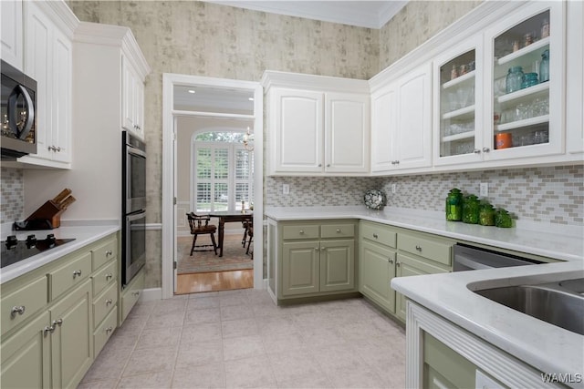 4032 Carousel Cir, Tuscaloosa, AL 35406 - kitchen with stainless steel appliances, green cabinetry, light countertops, tasteful backsplash, and crown molding
