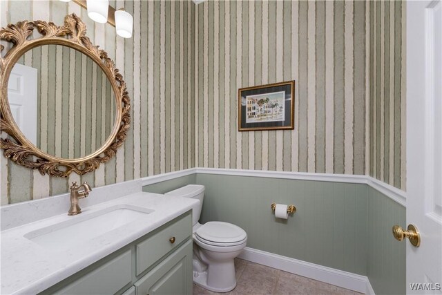 4032 Carousel Cir, Tuscaloosa, AL 35406 - half bath featuring a wainscoted wall, vanity, wallpapered walls, and tile patterned flooring
