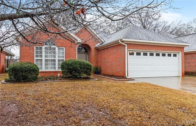 view of front of house with a front yard and a garage