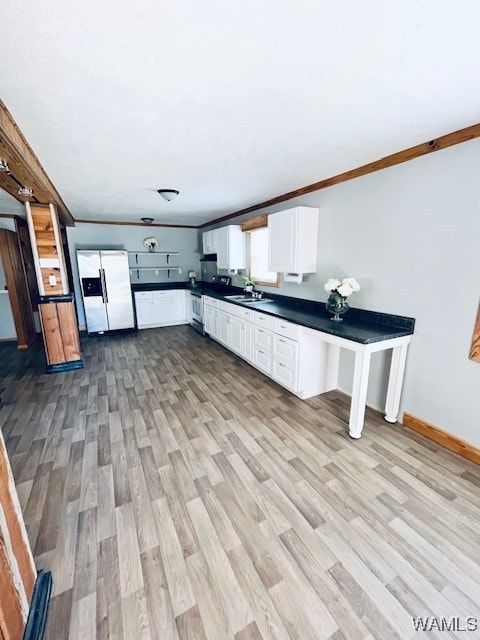 kitchen featuring sink, white refrigerator with ice dispenser, crown molding, light hardwood / wood-style floors, and white cabinets