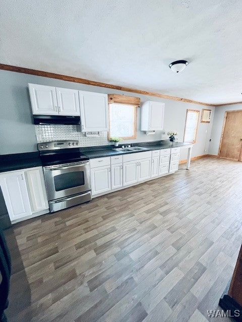 kitchen with white cabinetry, light wood-type flooring, stainless steel electric range oven, and sink