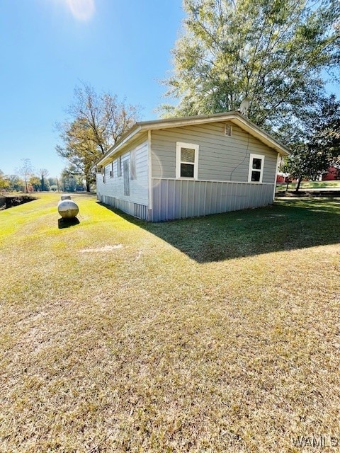 view of side of property with a lawn