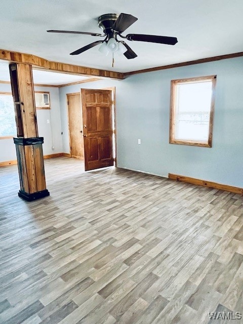 empty room with a wealth of natural light, ceiling fan, and light wood-type flooring