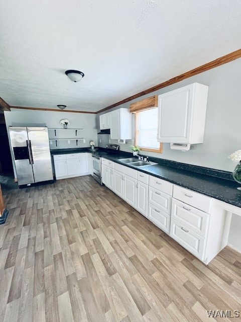 kitchen featuring white cabinets, stainless steel appliances, light hardwood / wood-style floors, and sink