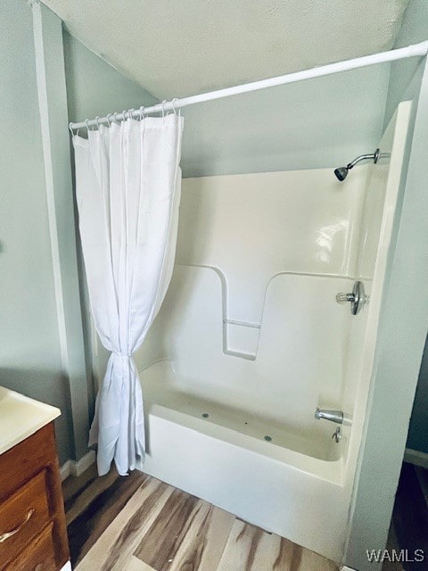 bathroom featuring vanity, hardwood / wood-style flooring, and shower / tub combo with curtain