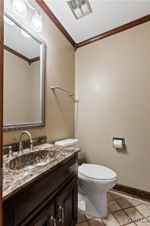 bathroom featuring crown molding, vanity, toilet, and tile patterned flooring