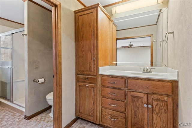 bathroom featuring vanity, toilet, and a shower with shower door