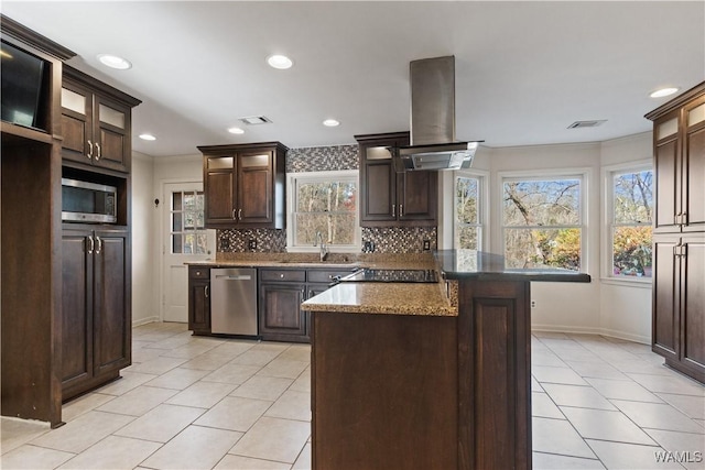 kitchen with dark brown cabinets, a kitchen island, island exhaust hood, stainless steel appliances, and backsplash