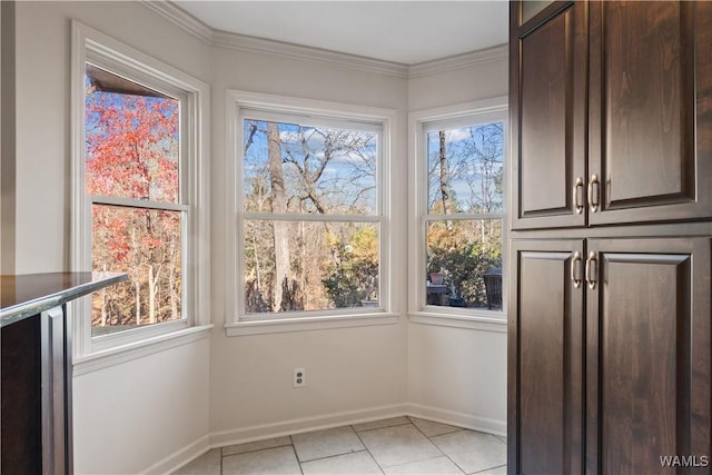 unfurnished dining area with crown molding and light tile patterned floors