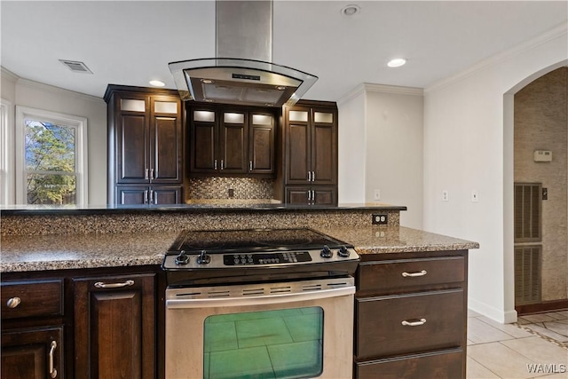 kitchen with crown molding, dark brown cabinetry, island range hood, and electric range