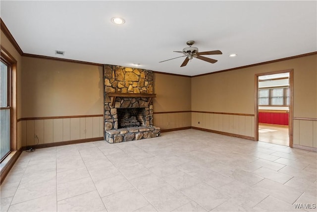 unfurnished living room with a fireplace, ornamental molding, and ceiling fan