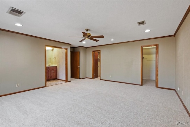 unfurnished bedroom with a spacious closet, light colored carpet, and a textured ceiling