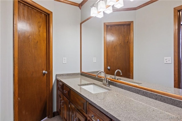 bathroom with ornamental molding and vanity