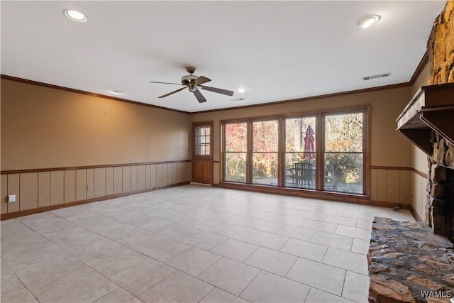 unfurnished living room with crown molding, plenty of natural light, light tile patterned floors, and ceiling fan