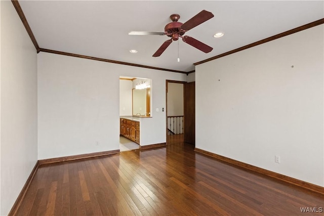 empty room with crown molding, hardwood / wood-style flooring, and ceiling fan