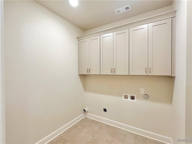 washroom featuring gas dryer hookup, hookup for an electric dryer, hookup for a washing machine, and cabinets