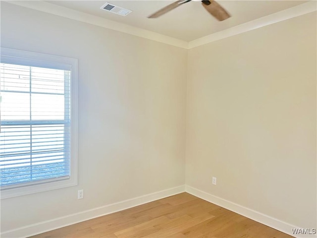 spare room with ceiling fan, ornamental molding, and light hardwood / wood-style floors