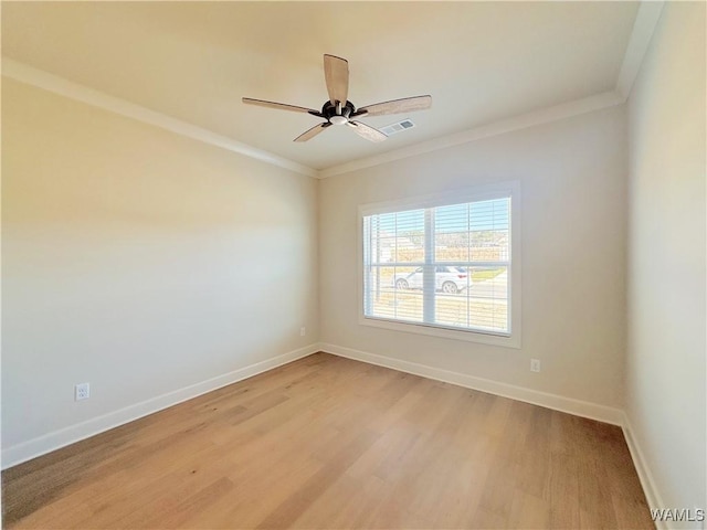 empty room featuring ceiling fan, crown molding, and light hardwood / wood-style floors