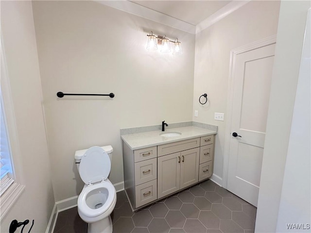 bathroom featuring toilet, vanity, and tile patterned flooring