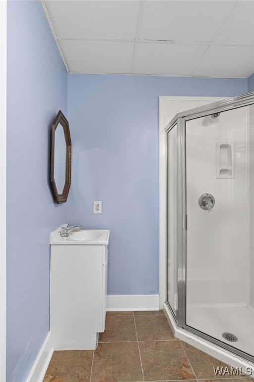 4184 Graves Gap Rd, Hayden, AL 35079 - bathroom featuring vanity, a shower stall, a paneled ceiling, and tile patterned flooring