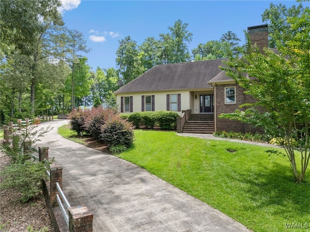 4184 Graves Gap Rd, Hayden, AL 35079 - view of front of house featuring a front lawn, driveway, brick siding, roof with shingles, and a chimney