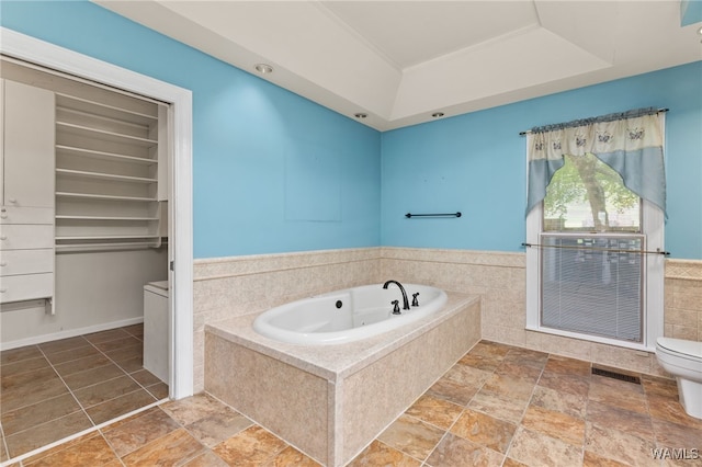 4184 Graves Gap Rd, Hayden, AL 35079 - full bathroom with a jetted tub, a tray ceiling, and stone finish floors