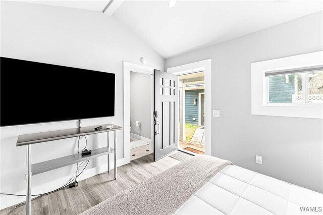 bedroom featuring vaulted ceiling and wood finished floors