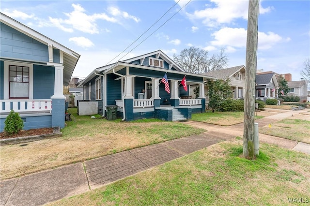 view of front facade with covered porch and a front yard