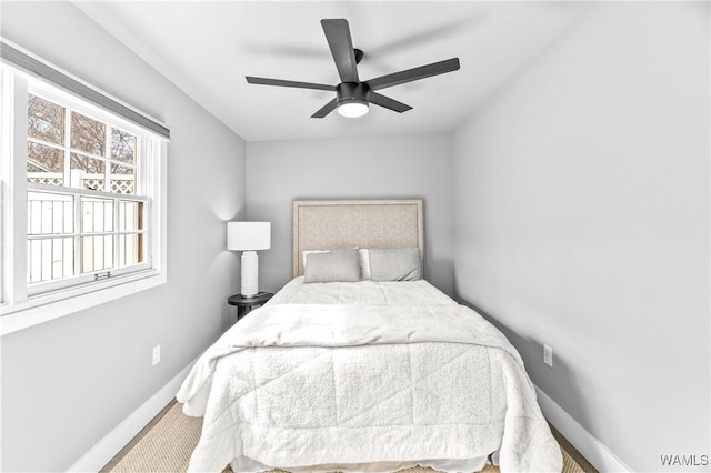 carpeted bedroom with a ceiling fan and baseboards