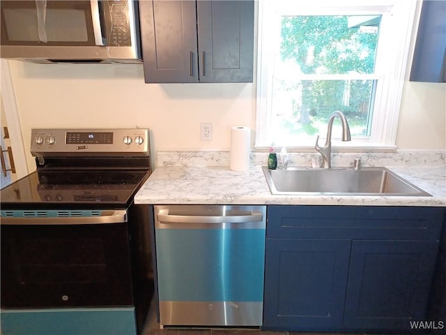2205 18th Ave, Northport, AL 35476 - kitchen featuring appliances with stainless steel finishes, a sink, and blue cabinets