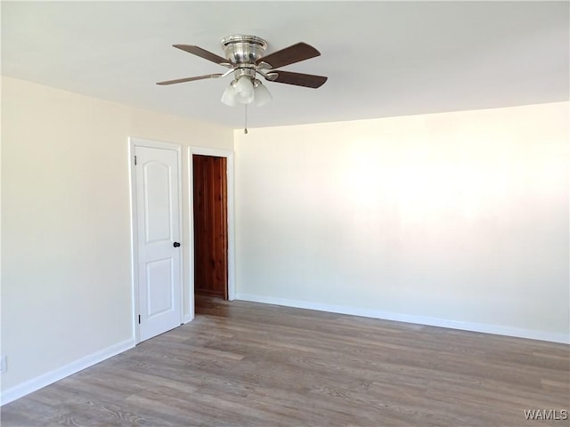 2205 18th Ave, Northport, AL 35476 - unfurnished room featuring wood finished floors, ceiling fan, and baseboards