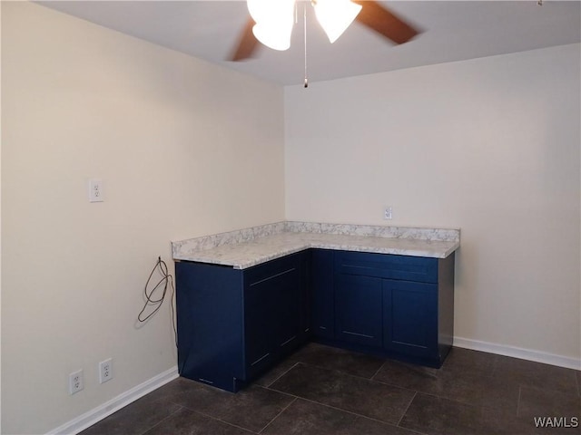 2205 18th Ave, Northport, AL 35476 - kitchen with ceiling fan, light countertops, baseboards, and blue cabinets